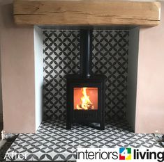 a wood burning stove sitting inside of a living room next to a wall with black and white tiles