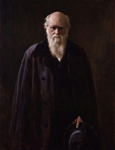 an old man with a long white beard wearing a black coat and holding a hat