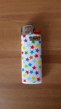 a lighter with colorful stars on it sitting on a table