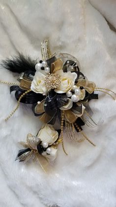 a bridal corsage with white flowers and black feathers