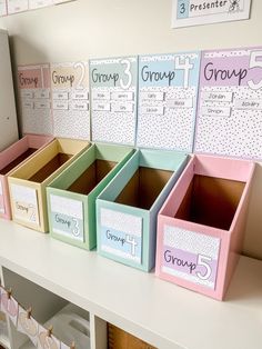 several boxes are lined up on the shelf in front of each other, labeled groups