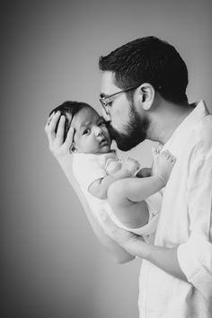 a man holding a baby in his arms