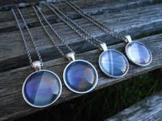 three pendants are sitting on a wooden bench