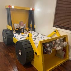 a child's bed made to look like a construction vehicle with wheels on it