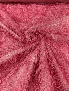 the texture of pink fur is shown in close up, as if it were an animal or bird's tail