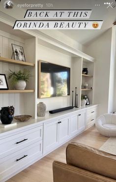 a living room filled with furniture and a flat screen tv on top of a wall