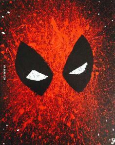 a close up of a deadpool face with white eyes and red paint splatters