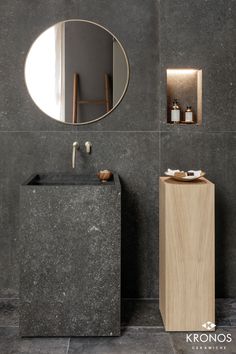 a bathroom with a sink, mirror and cabinet in grey marbled stone wallpaper