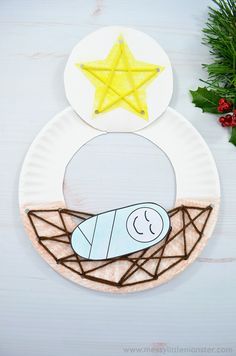 paper plate nativity craft for kids with an ornament and star on top