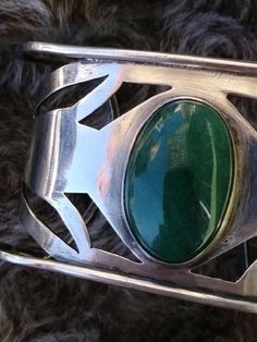 Sterling silver, tested Dark 'jade' green stone (Aventurine, we believe) Cuff style Designed with two cuffs, inner and outer Fits to wrists comfortably Well-made For men. For women. EXCELLENT for Plus sz Label/Stamp: none. This is vintage artisan made. 20171216J460 Condition: Excellent condition. No real wear. We notice a slight lifted edge in back; as made/found. Doesn't impair wearability and could be filed down if desired by new owner, we feel. We've not polished this, leaving that to owner. Silver Aventurine Bracelet Jewelry, Silver Aventurine Bracelet, Jade Green, Green Stone, Vintage 1970s, Vintage Boutique, Cuff Bracelet, Cuff Bracelets, 1970s