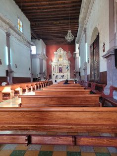 an empty church with pews and stained glass windows