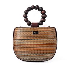 Introducing our new brown and tan Maria bag. This stunning bag offers a unique statement look with elevated luxury vacation moments in mind. You'll be sure to get admiring glances with this beautiful bag on your arm.  Crafted by artisans in the Philippines, this bag is created using woven Buntal straw - a natural and organic fiber from large leaves of abundant palm trees that are grown sustainably in the Philippines. Each piece of fiber is then meticulously handwoven to create a unique and natural textile that respects its origin.  The bag is complete with beaded top handles and  also comes with a detachable crossbody strap - perfect for when you need a hands free option. Made from Buntal weave and wooden beads Detachable crossbody strap Clean with a damp cloth Luxury Brown Box Bag For Travel, Vacation Crossbody Brown Bucket Bag, Vacation Brown Crossbody Bucket Bag, Luxury Brown Bucket Bag With Top Carry Handle, Elegant Bag With Bamboo Handle For Vacation, Elegant Vacation Bag With Bamboo Handle, Natural Color Bags With Bamboo Handle For On-the-go, Natural Bags With Bamboo Handle For On-the-go, Luxury Bags With Bamboo Handle For On-the-go