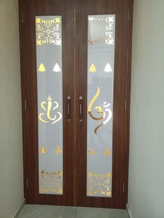 two glass doors with gold designs on them