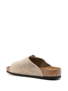 Find BIRKENSTOCK Zurich Buckled Slip-on Sandals on Editorialist. taupe suede buckle fastening slip-on style open toe moulded footbed flat rubber sole Beige Leather Slip-on Footbed Sandals, Beige Leather Closed Toe Footbed Sandals, Suede Slip-on Slippers With Buckle Closure, Beige Suede Mules With Textured Footbed, Beige Closed Toe Sandals With Cork-bed Midsoles, Beige Slides With Textured Footbed And Round Toe, Suede Sandals With Leather Footbed And Slip-on Fit, Suede Slip-on Sandals With Leather Footbed, Beige Buckle Closure Slip-on Footbed Sandals