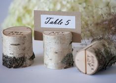 there are three pieces of wood that have been made into place cards for each other