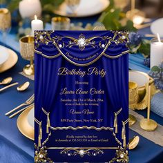 a blue and gold birthday party is set up on a table with plates, silverware, and candles