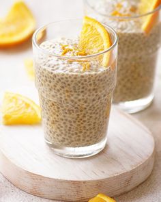 two glasses filled with oatmeal and orange slices