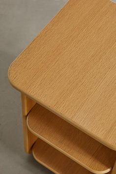 a wooden table with three shelves on each side