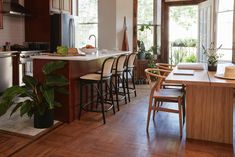 a kitchen filled with lots of counter top space next to a dining room table and chairs