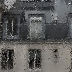 rain is falling on the windows and buildings