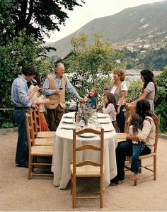 a group of people standing around a table