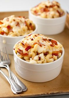 two white bowls filled with macaroni and cheese