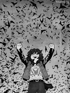 a woman standing in front of a flock of bats with her arms up and hands raised