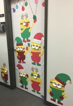 the door to an office decorated with christmas decorations and minion character stickers on it