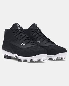 the under armour football shoe is black and white