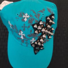 Turquoise Studded Cross Adjustable Hat Mcbling Hat, Trendy Blue Hats For Festival, Trendy Blue Hat For Festival, Casual Turquoise Cap Hat, Casual Turquoise Cap, Turquoise Hats With Short Brim, Trendy Green Hat For Festival, Trendy Green Hat For Festivals, Turquoise Casual Hat For Spring