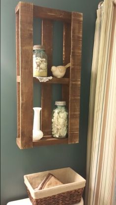 a bathroom with a wooden shelf above the toilet