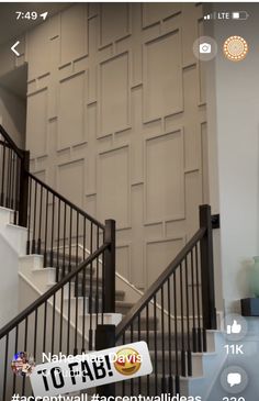 the stairs in this house are made of wood and black wrought iron railings, with an accent wall behind them