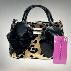 Brand New! Super Cute Bag Done In A Velvet Cheetah Print Trimmed In Black Patent. Large Black Patent Bow On The Front With A Gold Logo Plate In The Center. Bag Comes With A Detachable Strap So It Can Be Carried As A Satchel Or Worn As A Crossbody. Handles Are Black Patent & Drop 3”. Strap Is A Combo Of Gold Chain & Patent With Swivel Lobster Claw Clasps & Drops 22.5”. Full Zip Close Interior Is Lined In Betsey Johnson’s Signature Floral Lining And Has A Slip Pocket Bag Measures 8w X 5.25h X 5.5d Brown Party Bag With Adjustable Strap, Chic Brown Satchel For Party, Brown Party Bags With Adjustable Strap, Brown Party Bags For Fall, Fall Party Brown Bags, Betsey Johnson Designer, Chic Leopard Print Party Bag, Brown Fall Party Bags, Chic Leopard Print Party Bags