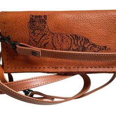 This Is A Unique 100% Vegetable Tanned Leather Wallet And Cross Body Phone Carrier With A 25-30 Inch Calf Skin Removable And Adjustable Strap And Secure Velcro Closures. It Has A Unique Laser Printed Tiger On The Front. It Is Sewn Together By Hand With Chinois Noir Thread, A Stronger And Thicker Thread Used By Luxury Bag Makers. It Closes With Heavy Duty Velcro Straps To Keep Everything Secure. It Fits A Plus Size Cased Cell Phone As Well As Cash And Multiple Cards. It Is Designed To Last Years Brown Leather Clutch With Mobile Phone Bag, Casual Leather Clutch For Everyday Use, Casual Leather Clutch For Daily Use, Light Brown Leather Wallet For Everyday Use, Brown Leather Clutch With Snap Closure, Leather Crossbody Wallet With Snap Closure, Casual Brown Wallet With Removable Pouch, Brown Bifold Clutch For Everyday Use, Casual Leather Wallets For Everyday Use