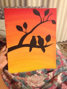 a painting of two birds sitting on a tree branch in front of an orange and yellow background