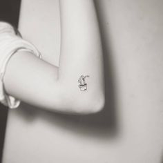 a woman with a small tattoo on her arm