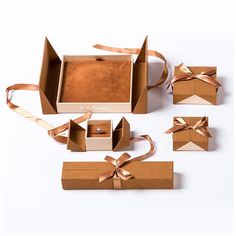 an open box with four pieces of brown paper tied around it and two rings on each side