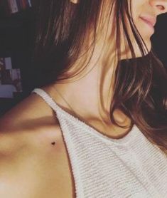 a close up of a person wearing a white top