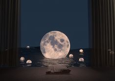 a full moon sitting in the middle of an ocean next to some columns and lights