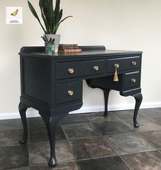 a black desk with a potted plant on top