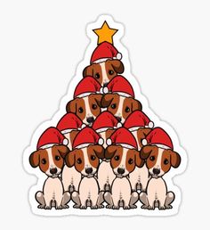 a group of dogs wearing santa hats and sitting in front of a christmas tree sticker