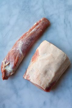 two pieces of meat sitting on top of a counter