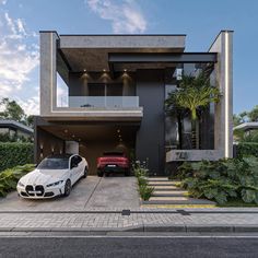 two cars parked in front of a modern house