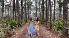 two young women walking through the woods together