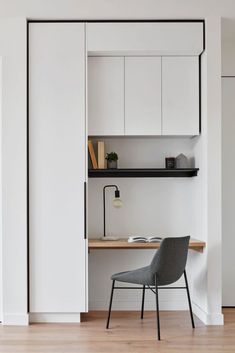 a chair sitting in front of a white cabinet