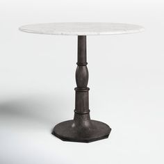 a white marble top table with metal base