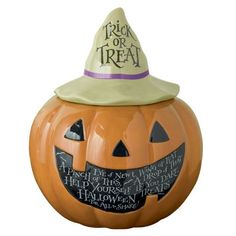 a ceramic pumpkin with a witches hat on it's head and writing on the side