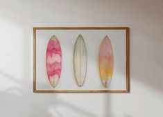 three surfboards are hanging on the wall