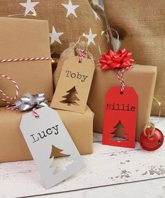 christmas presents are wrapped in brown paper and tied with twine, red ribbon and tags