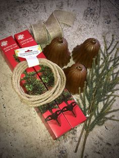 christmas decorations are on display in front of a red box with twine and ribbon